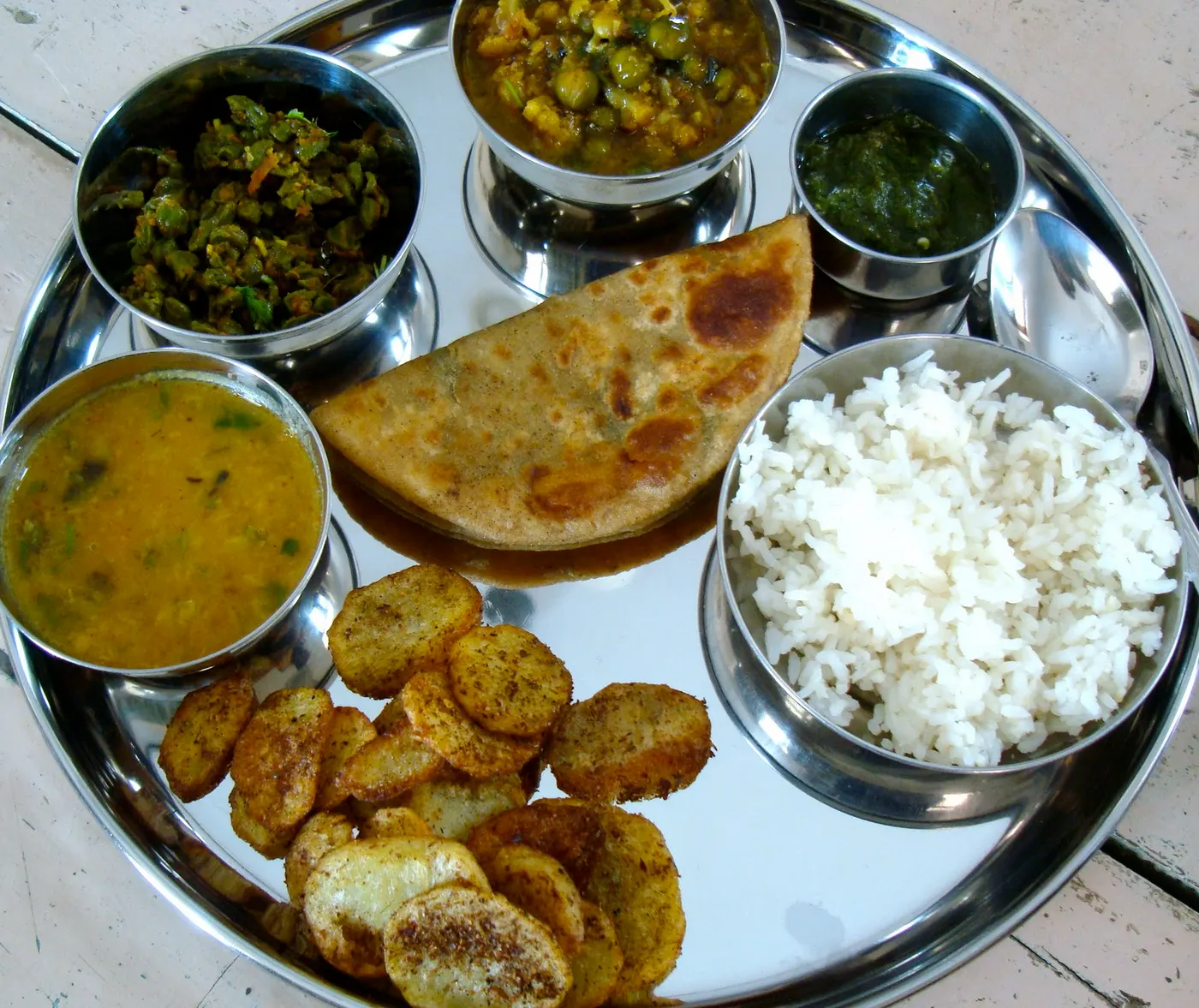 From the kitchen of Meenakshi - A well balanced combination of rice, daal, three different vegetables, salad and a delicious flaky bread.