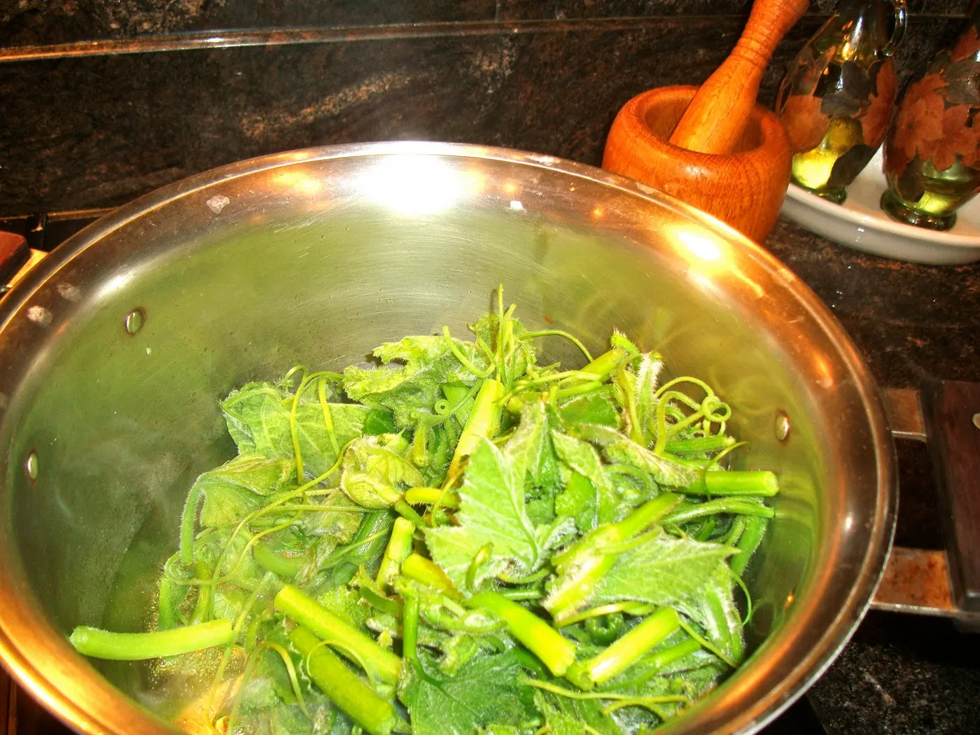 Cooking until shoots are tender and have reduced to half of their original volume