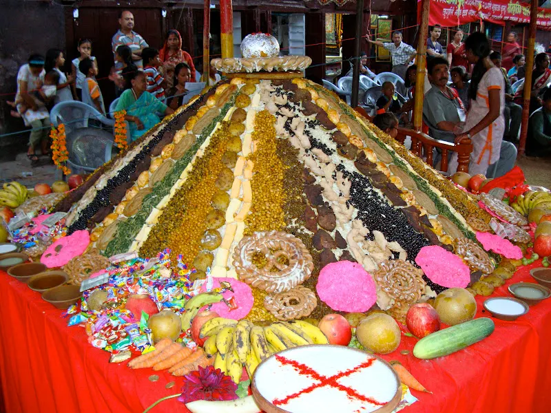 Close-up view of Samay Baji in front of Annapurna Mandir, Ason Tole. The whole display of Samay Baji is topped off with the local ceremonial bread, laakha mari, and a large chickpeas flower sweet (laddu) is placed on the top.