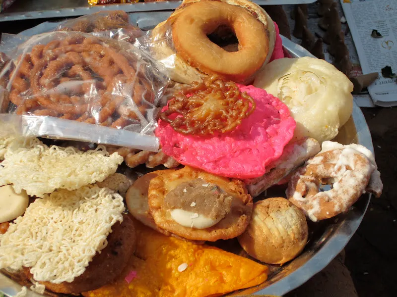 Several variety of local sweets is placed around Samay Baji by devotees.