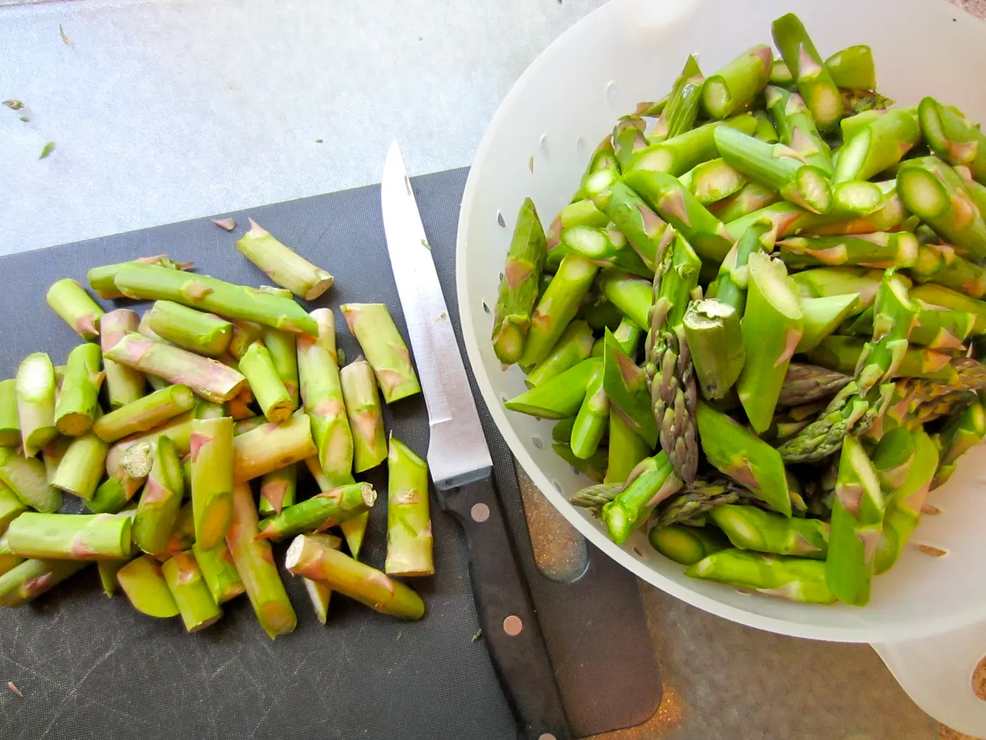 To prepare the asparagus, trim off any section of the spears that is not green. Break the stalks at the point where the woody parts meet the tender stalks. Slice the stalks diagonally into 1 1/2-inch pieces.