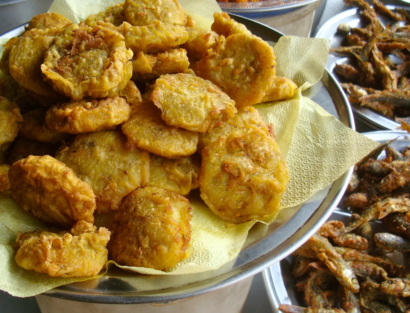 Potato pakauda (batter-based savory fritters) - a perfect accompaniment served with fried fish.