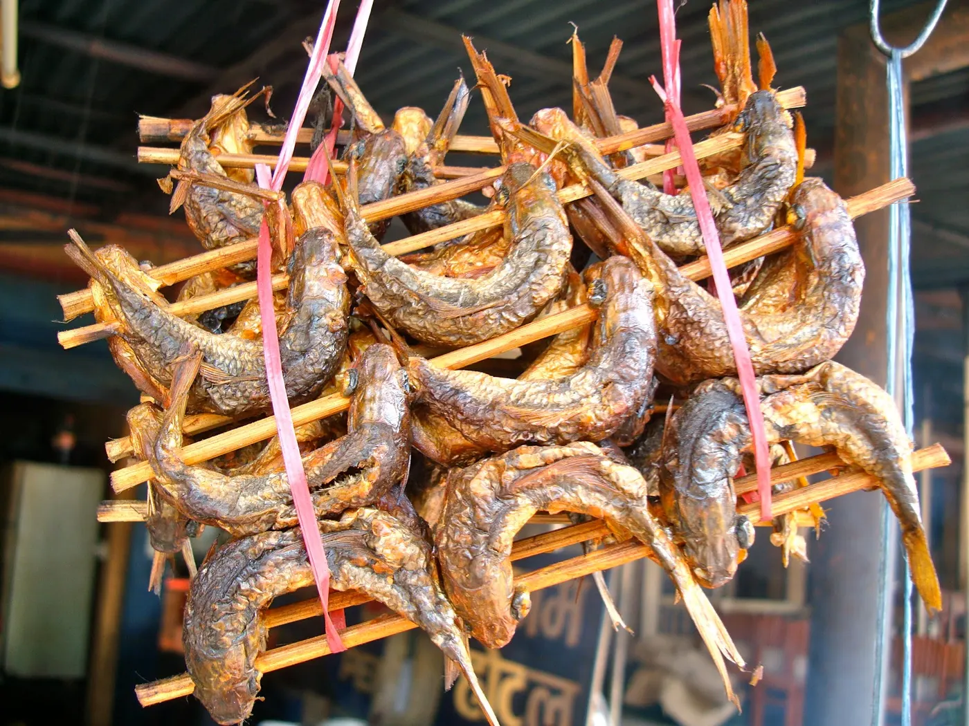 Here is another picture of smoked river fish sold in a long wooden stick.