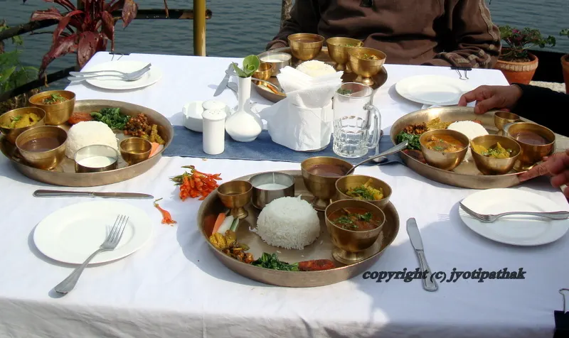Enjoying the Nepali Thaali lunch served in Kaas ko Thaal, at the outdoor multi-level garden of Lychee Garden Resort, Pokhara, Nepal