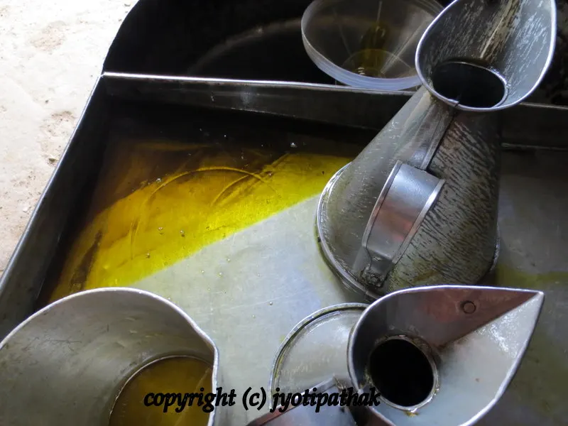 The final packaging - pure mustard oil is getting ready to be poured up into the bottle.