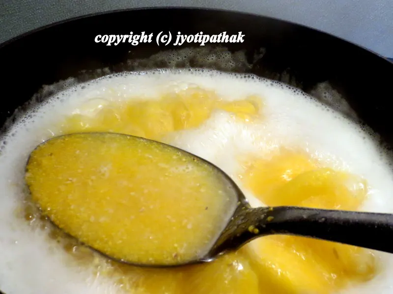 Reduce the heat to medium-low and continue stirring until dhindo thicken, and the mixture has lost its grainy texture.