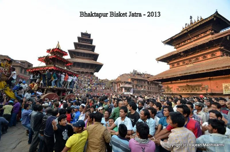 ...the chariot is being pulled slowly by holding a thick rope that is attached to the chariot....