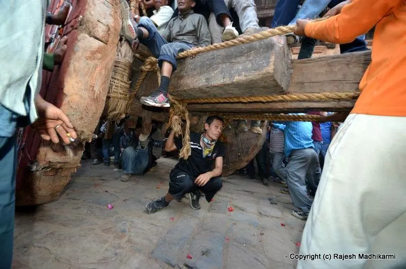 ... wonderful photo shot by Rajesh Madhikarmi - a man sitting underneath the wooden chariot to check the rope....