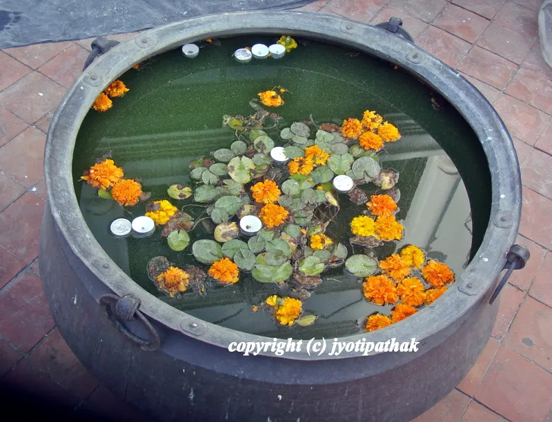 ... gorgeous antique khadkalo pot - the water lilies with small leaf is covering the entire pot, but some yellow and orange marigold with floating candles adds highlight of color throughout ...
