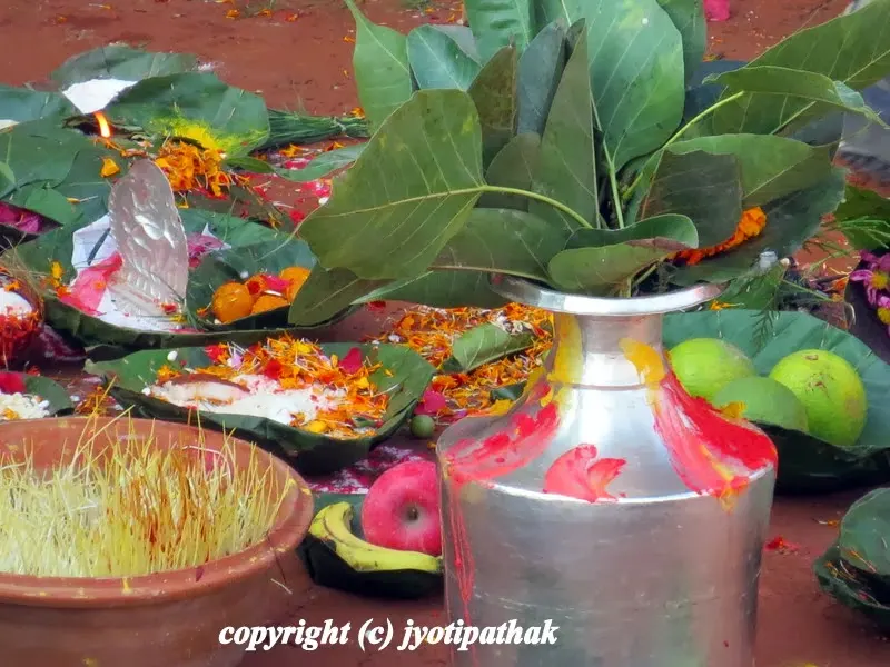 The auspicious Kalasha (कलश), full of holy water is decorated with red and yellow vermillion paste