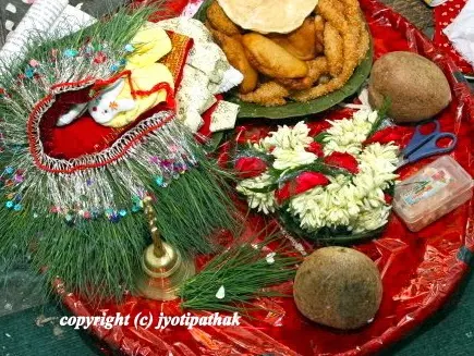 Another tray of religious offerings to deities - decorated grass garland, whole coconut, dubo grass bunches, traditional sweets - have an important role in many Nepali religious rituals.