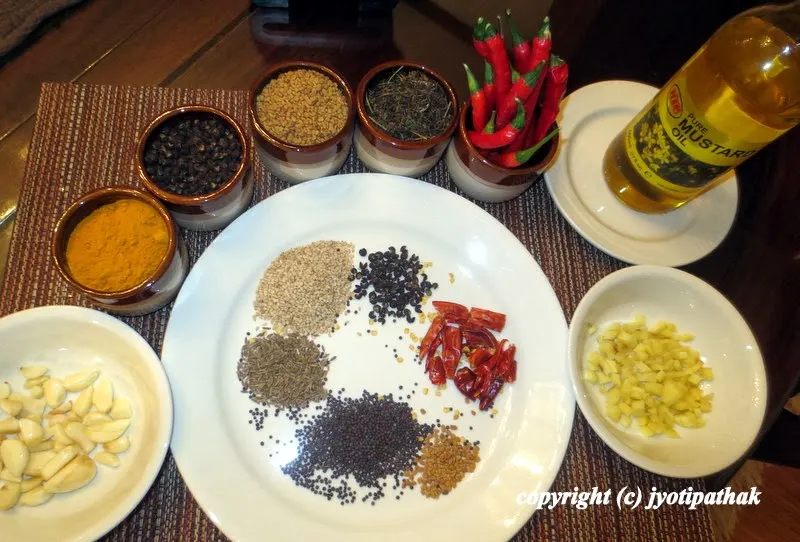 Here's what you will need to make tomato pickle - sesame seeds, dried chilies, timmur (szechwan pepper), cumin seeds, mustard seeds, fenugreek seeds, ground turmeric, jimbu, fresh garlic and ginger, green chilies and mustard oil.