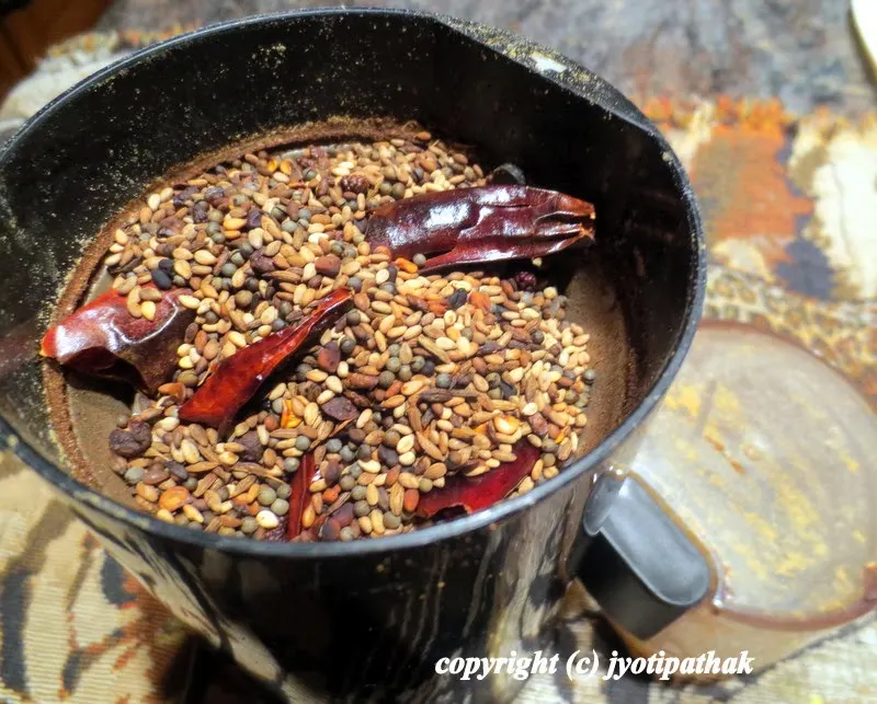 ... transferring the roasted spices into a spice grinder