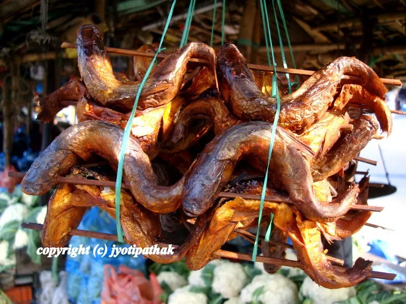 Special treat from Malekhu Bazaar, Nepal - sun-dried fish on a wooden sticks for sale - the small whole fish is weaved into a thin bamboo skewer, and dried in a traditional way.
