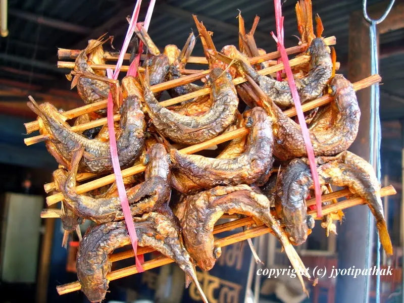 Here comes the another picture of curled-up dried fish from Malekhu Bazaar. Before adding to the cooked tomato pickle, the skin and bone of the dried fish needs to be removed.