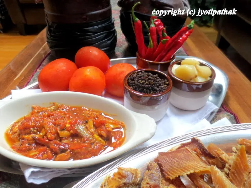 The dried fish is torn into small bite-size pieces then fried in the oil until crisp before adding to the tomato achaar. The fish will slightly soften once mixed with cooked pickle and you will be savoring the delicious flavored achaar.