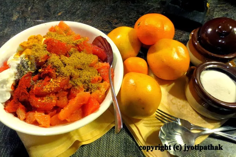 Combine the grapefruit with orange segments, dry-roasted sesame seeds, plain yogurt, sugar, fresh lemon juice, cayenne pepper, ground black pepper, timmur, and salt to taste in a mixing bowl.