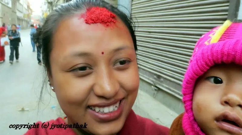 A mother and her young son - walking in the festive mood in the street of Kathmandu - welcoming relatives and everything in between
